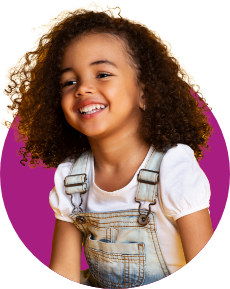 Smiling young girl wearing overalls