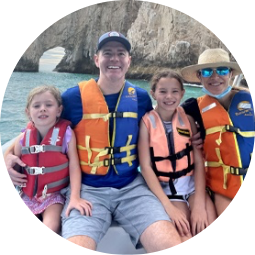 Doctor Dean and his family wearing lifejackets on a boat