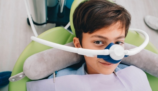 Young boy in dental chair wearing nitrous oxide sedation mask